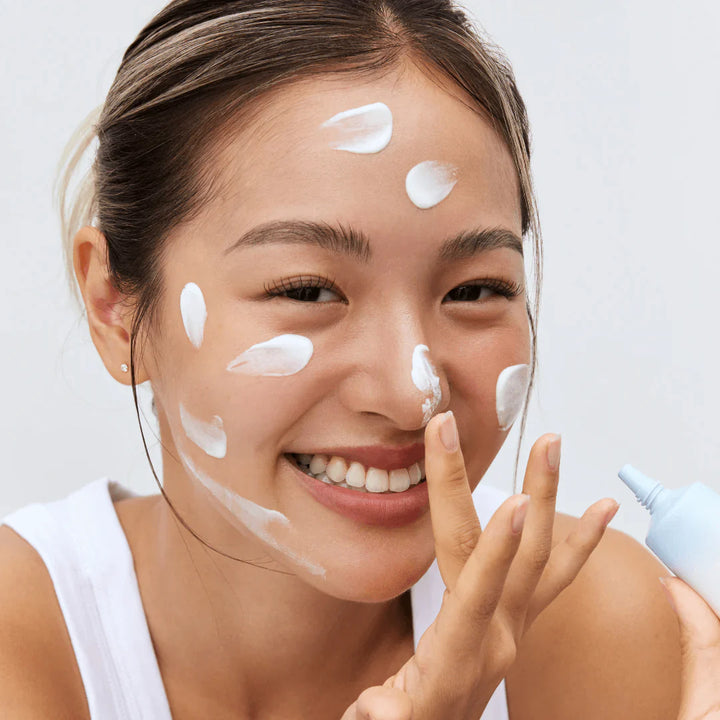 Application: applying sunscreen onto face under daylight