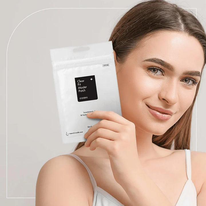 Model holding COSRX pimple patch pack.