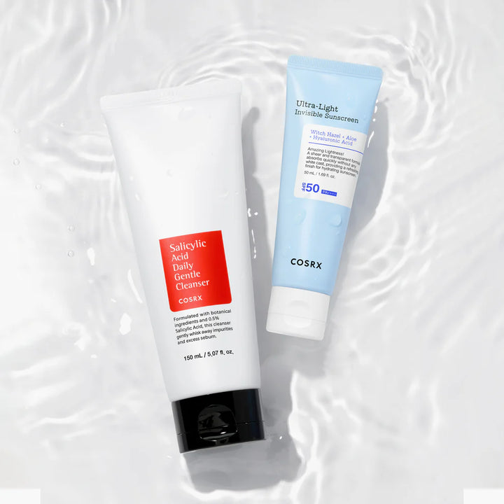 Flatlay of COSRX Salicylic Acid Cleanser and Ultra-Light Invisible Sunscreen on rippling water