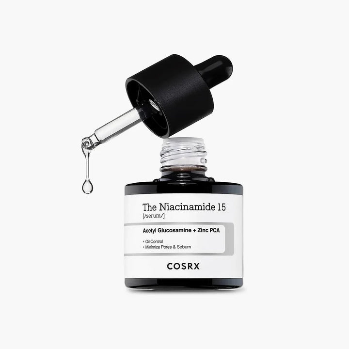 “Close-up of Niacinamide 15% serum dispensing drop via dropper”